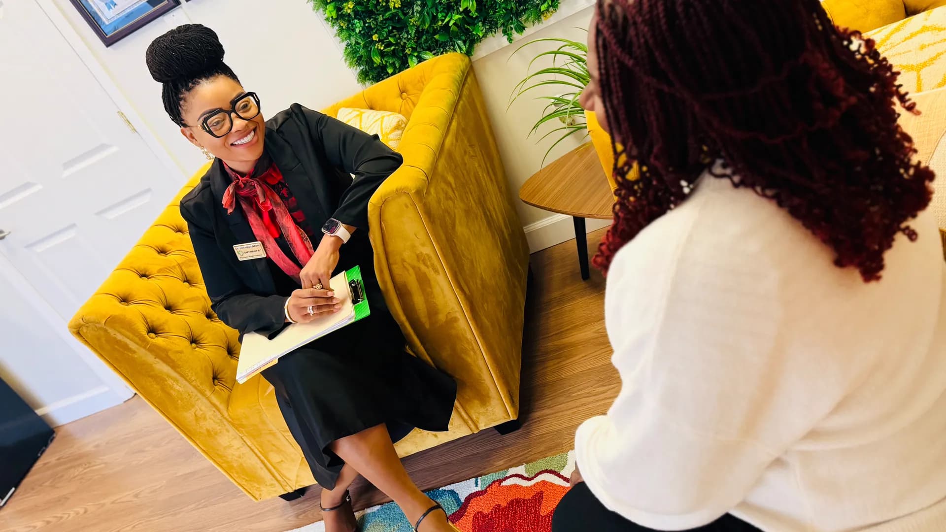 Two adults seated in conversation in a welcoming office